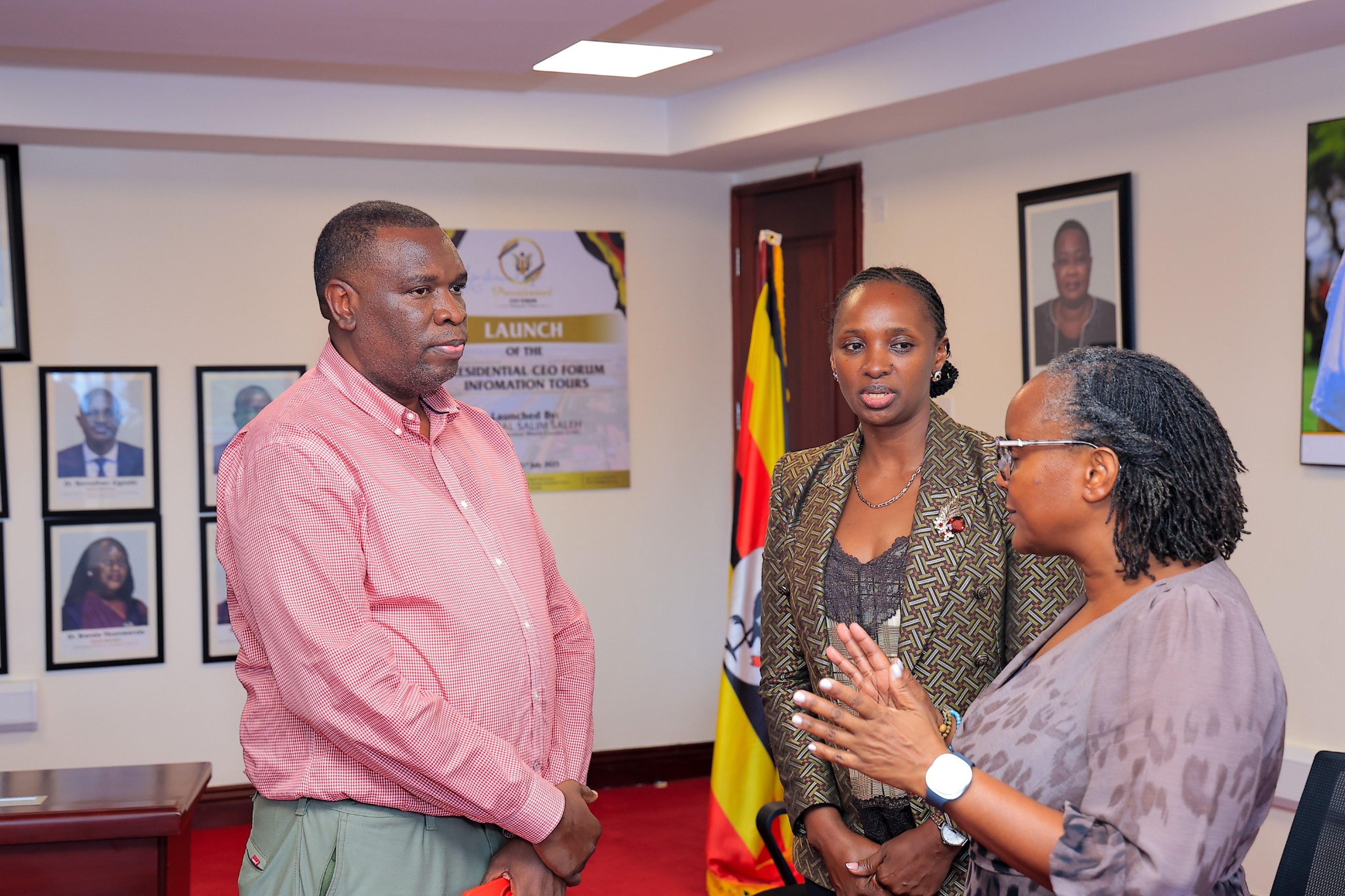 Mr. Paul Isaac Musasizi, Chief Executive Officer of Kiira Motors Corporation (left), engages in discussion with Mrs. Irene Birungi Mugisha, CEO of the Presidential CEO Forum (centre), during an E-Mobility stakeholder engagement meeting at the PCF Secretariat in July 2026